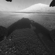Curiosity rover tracks point toward Mt. Sharp. NASA/JPL photo.